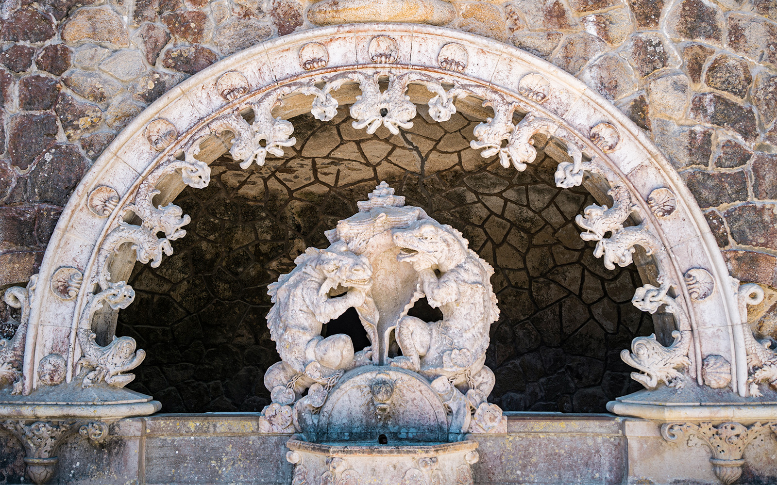 Tour guide with group in Quinta da Regaleira gardens, Sintra, Portugal.
