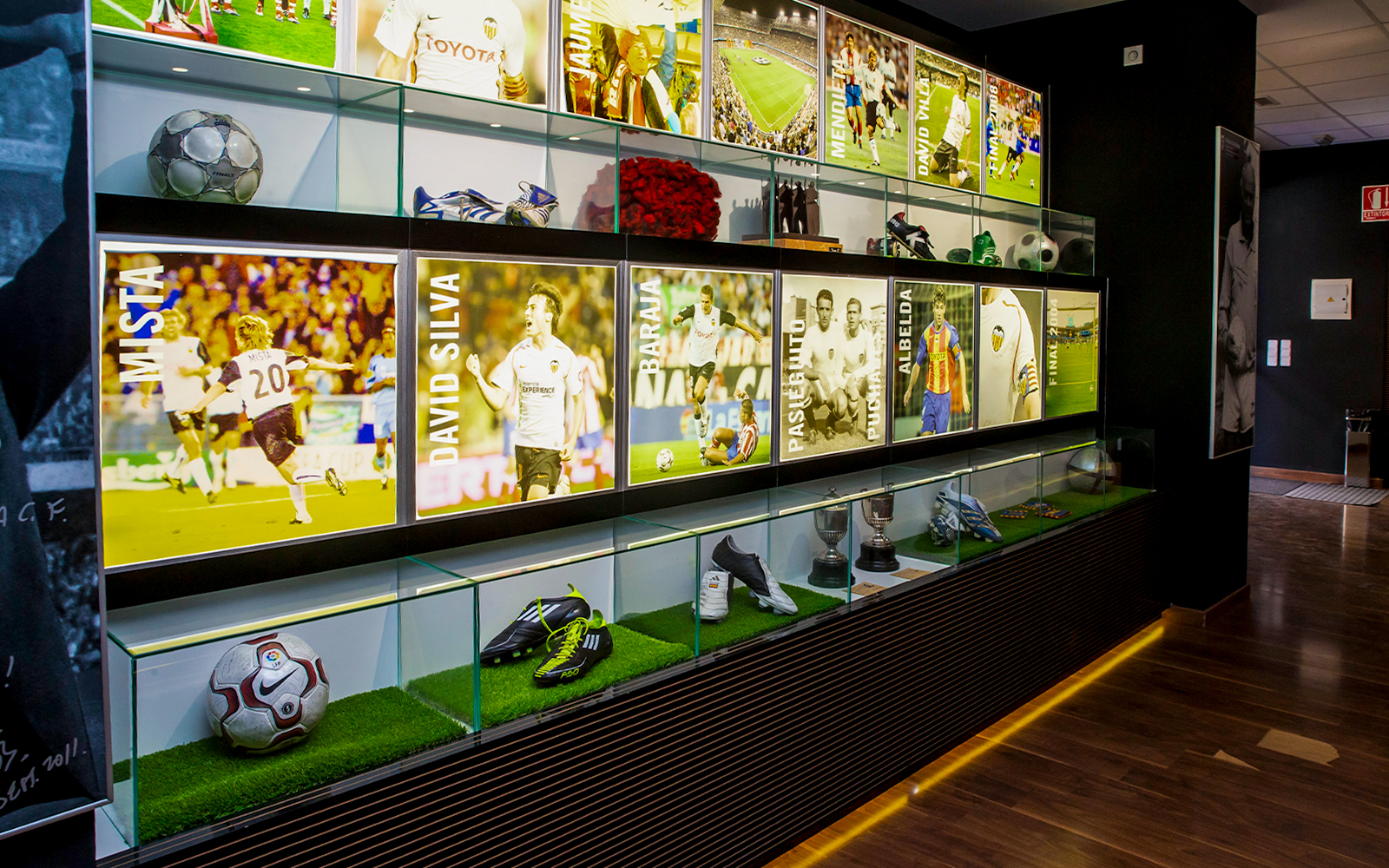 Valencia CF Mestalla Forevertour display with player memorabilia and trophies.