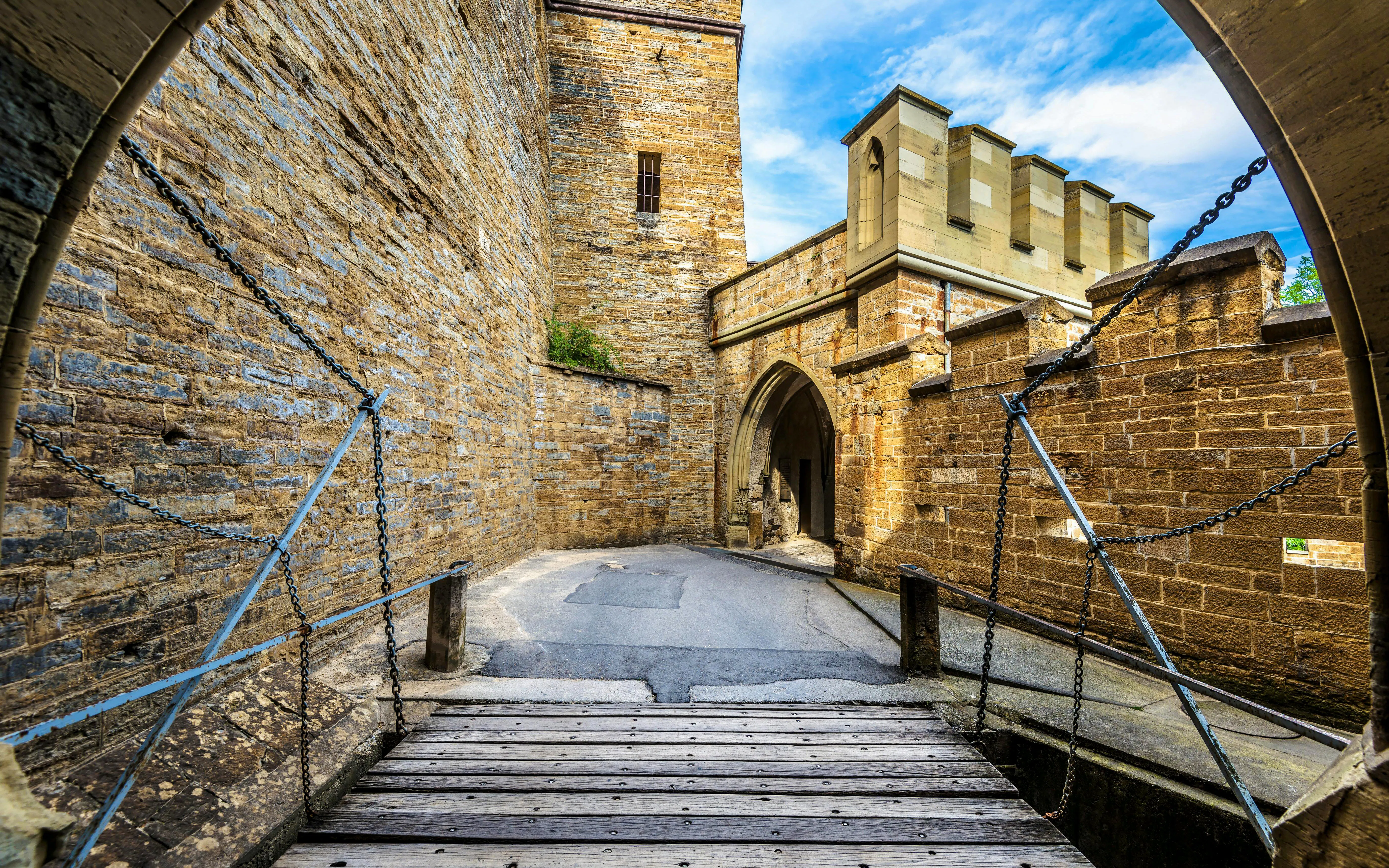 Hohenzollern Castle entrance with drawbridge and stone walls, Germany.