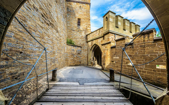 Hohenzollern Castle entrance with drawbridge and stone walls, Germany.