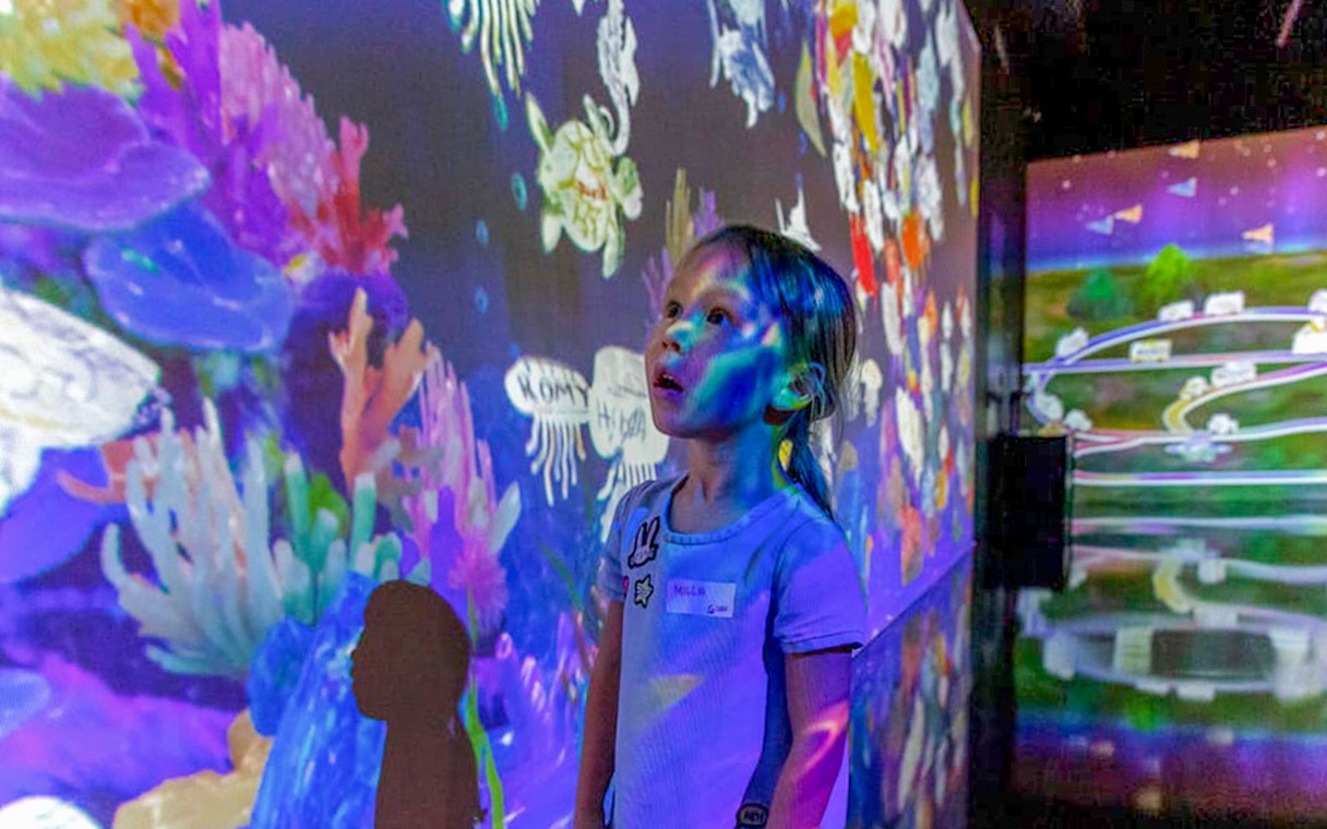 Child exploring interactive display at Future Park, Olioli Children's Museum, Dubai.