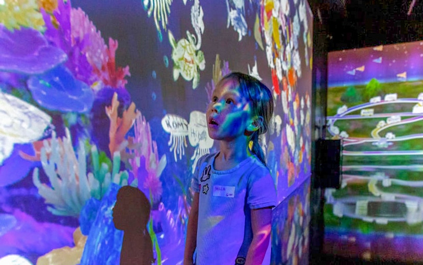 Child exploring interactive display at Future Park, Olioli Children's Museum, Dubai.