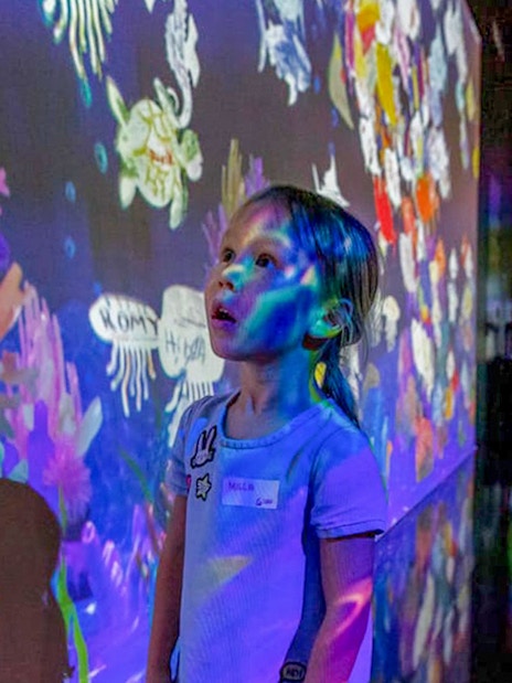 Child exploring interactive display at Future Park, Olioli Children's Museum, Dubai.