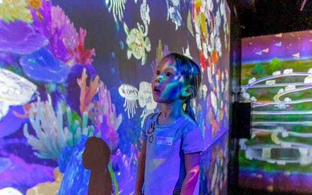 Child exploring interactive display at Future Park, Olioli Children's Museum, Dubai.