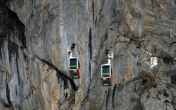 Cable cars ascending rocky cliffs at Fuente De, Spain.