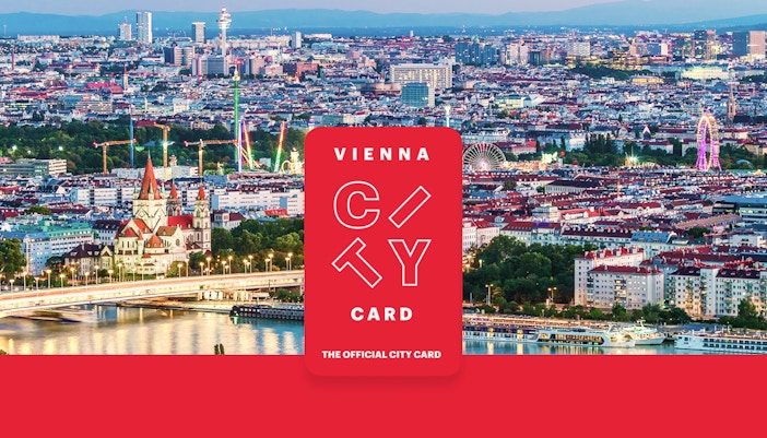 Aerial view of Vienna with skyscrapers, historic buildings, and riverside promenade.