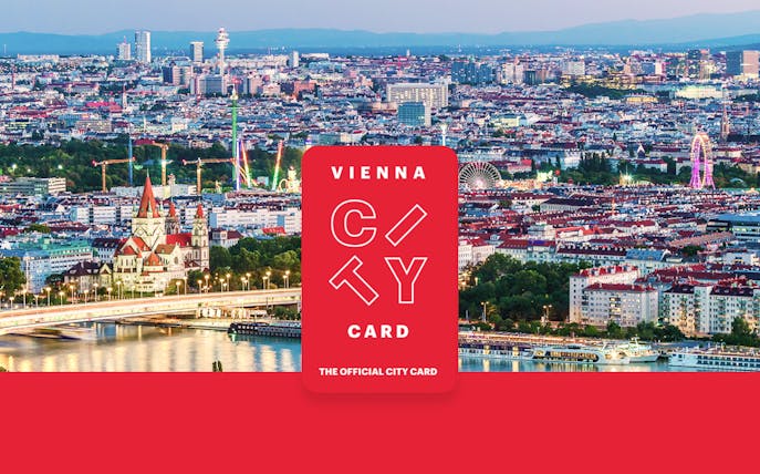 Aerial view of Vienna with skyscrapers, historic buildings, and riverside promenade.