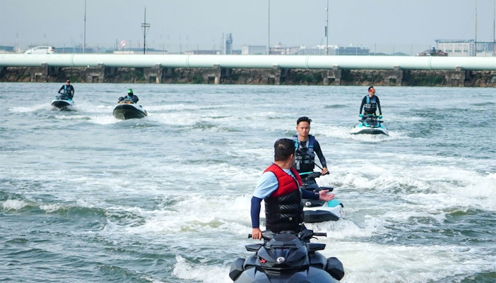 Jet skiers on Seadoo Safari in Johor Bahru, riding in formation on open water.