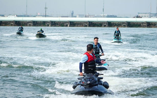 Jet skiers on Seadoo Safari in Johor Bahru, riding in formation on open water.