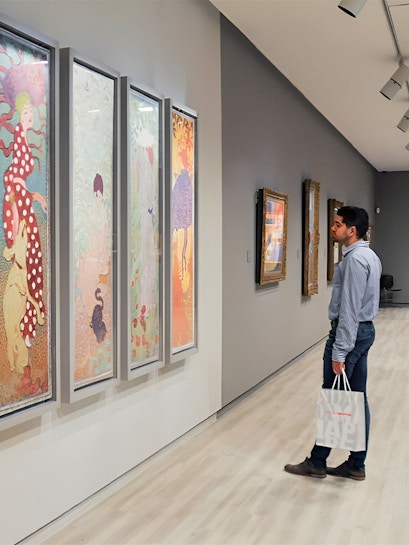 Visitor admiring colorful art at Fundación MAPFRE Madrid gallery.