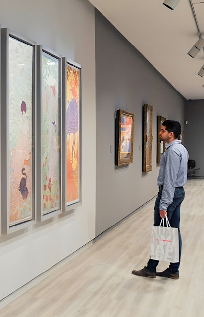 Visitor admiring colorful art at Fundación MAPFRE Madrid gallery.