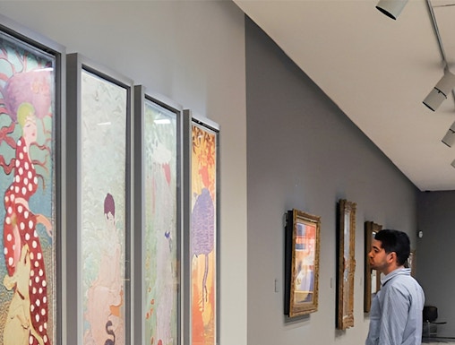 Visitor admiring colorful art at Fundación MAPFRE Madrid gallery.