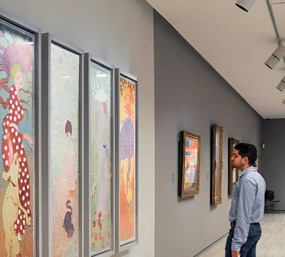 Visitor admiring colorful art at Fundación MAPFRE Madrid gallery.