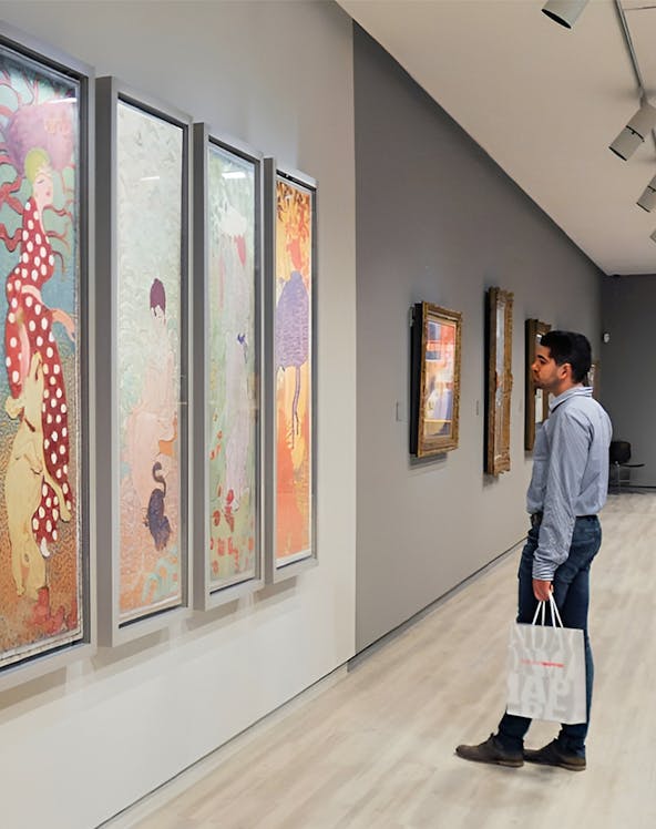 Visitor admiring colorful art at Fundación MAPFRE Madrid gallery.
