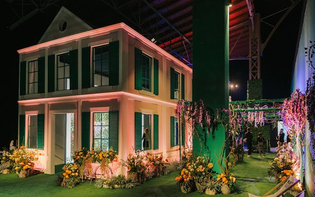 Monet’s Garden Immersive Exhibition with floral displays and a replica house.