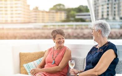 Two women enjoying a conversation on a Darwin Harbour lunch cruise.