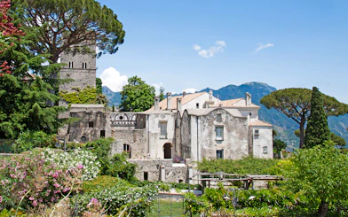Villa Rufolo in Ravello, Italy, surrounded by lush gardens and mountainous backdrop.