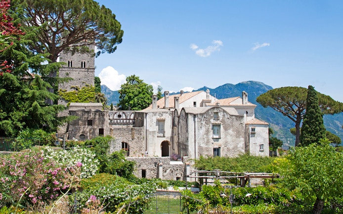 Villa Rufolo in Ravello, Italy, surrounded by lush gardens and mountainous backdrop.