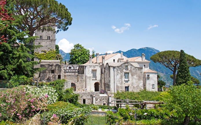 Villa Rufolo in Ravello, Italy, surrounded by lush gardens and mountainous backdrop.