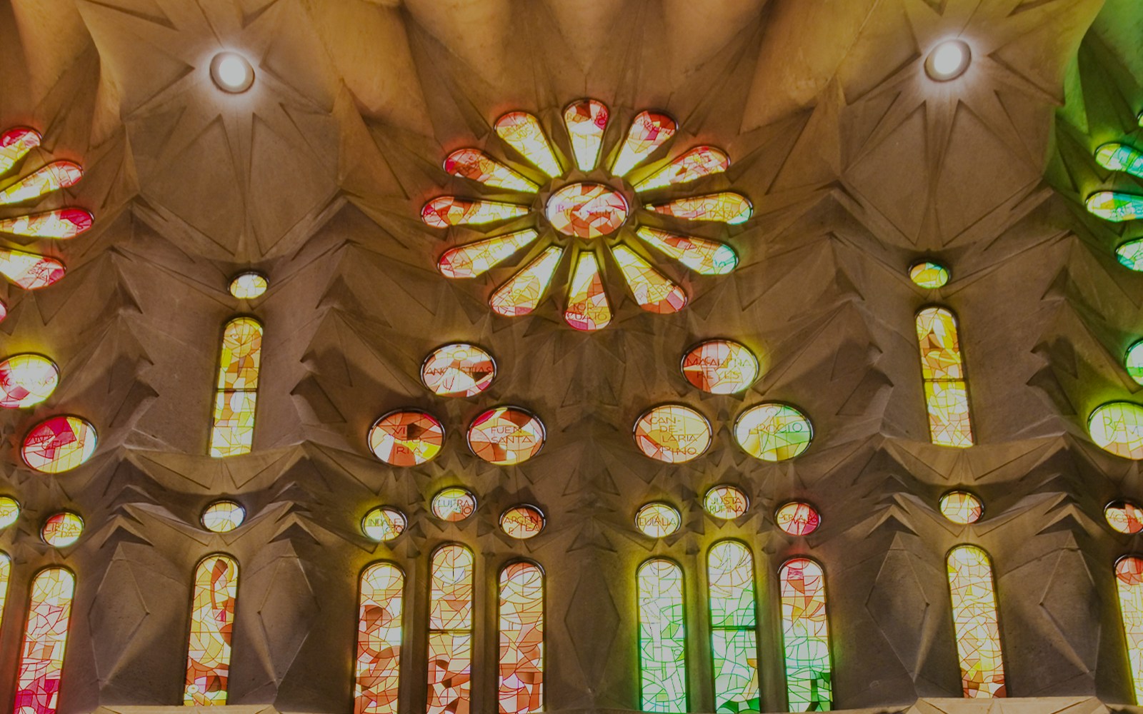Stained glass windows inside Sagrada Familia, Barcelona, displaying vibrant colors.