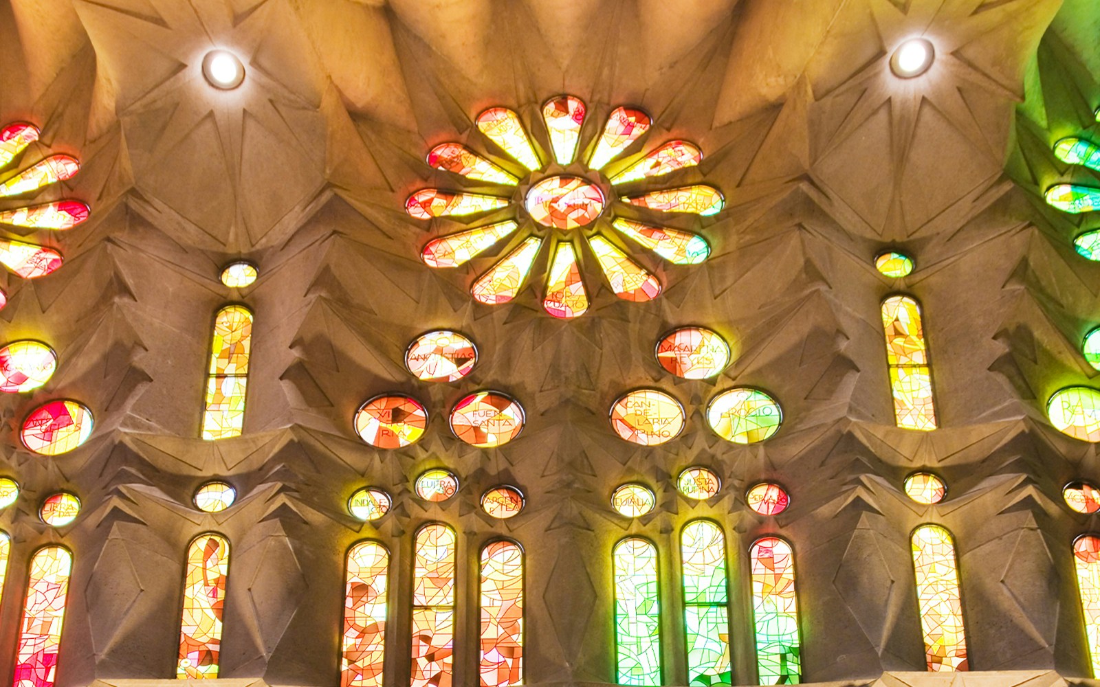 Stained glass windows inside Sagrada Familia, Barcelona, displaying vibrant colors.