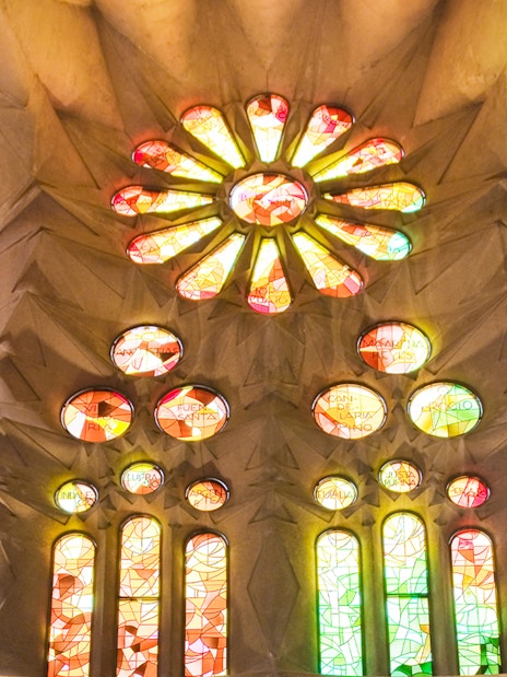 Stained glass windows inside Sagrada Familia, Barcelona, displaying vibrant colors.