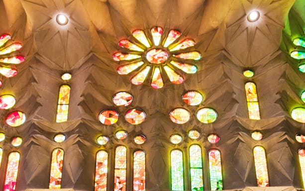 Sagrada Familia stained glass windows in Barcelona, highlighting vibrant colors and intricate designs.