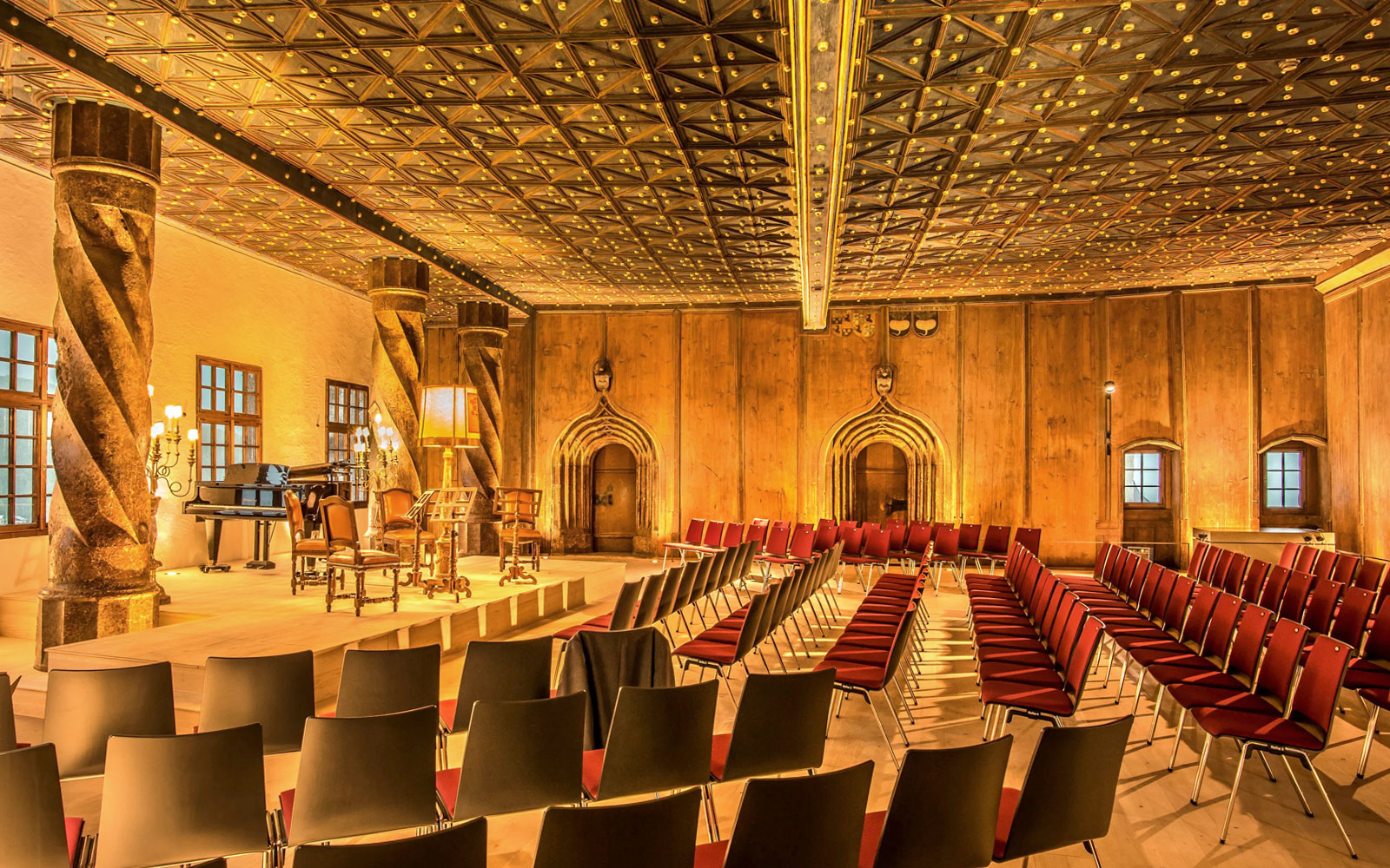 Fortress Hohensalzburg concert hall with empty seats and stage in Salzburg, Austria.