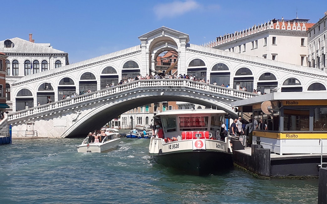 ACTV water bus on Venice's Grand Canal near Rialto Bridge.