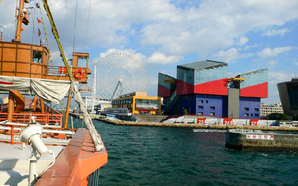 Santa Maria cruise ship view of Osaka Aquarium Kaiyukan and Tempozan Ferris Wheel across the bay.