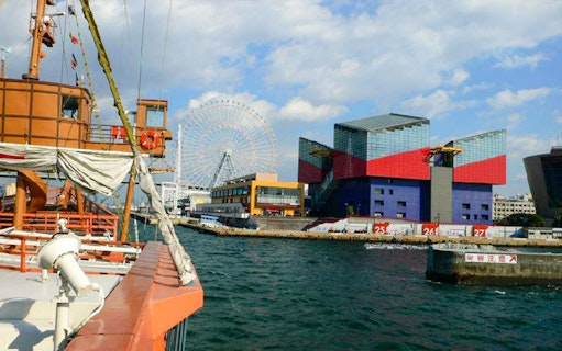 Santa Maria cruise ship view of Osaka Aquarium Kaiyukan and Tempozan Ferris Wheel across the bay.