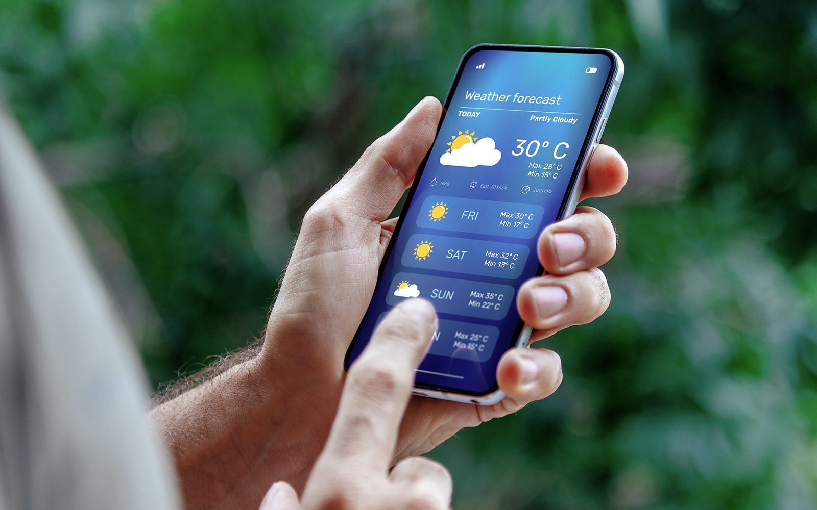 Man checking weather on phone in urban setting.