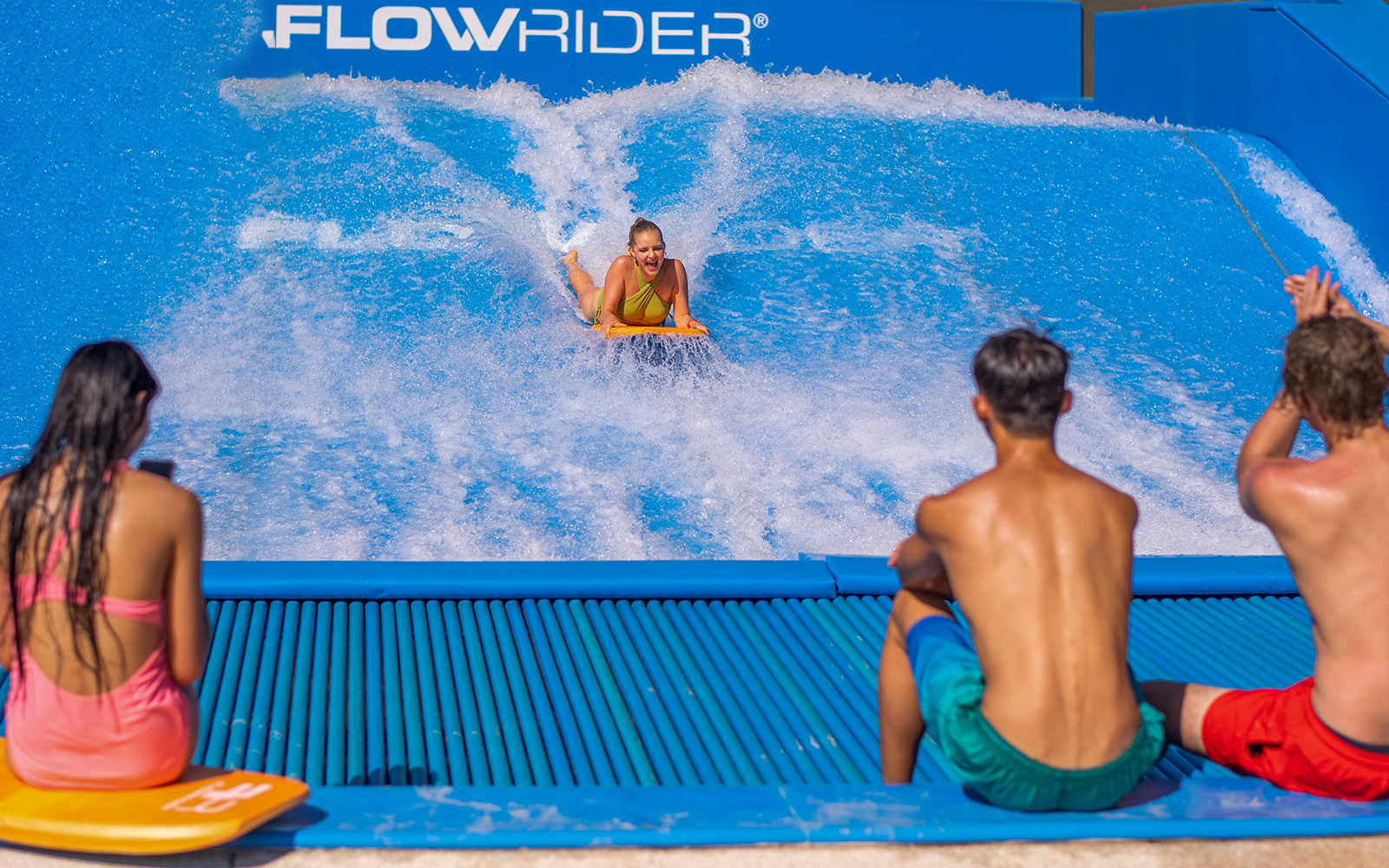 People surfing on the Flowrider at Andamanda Phuket.