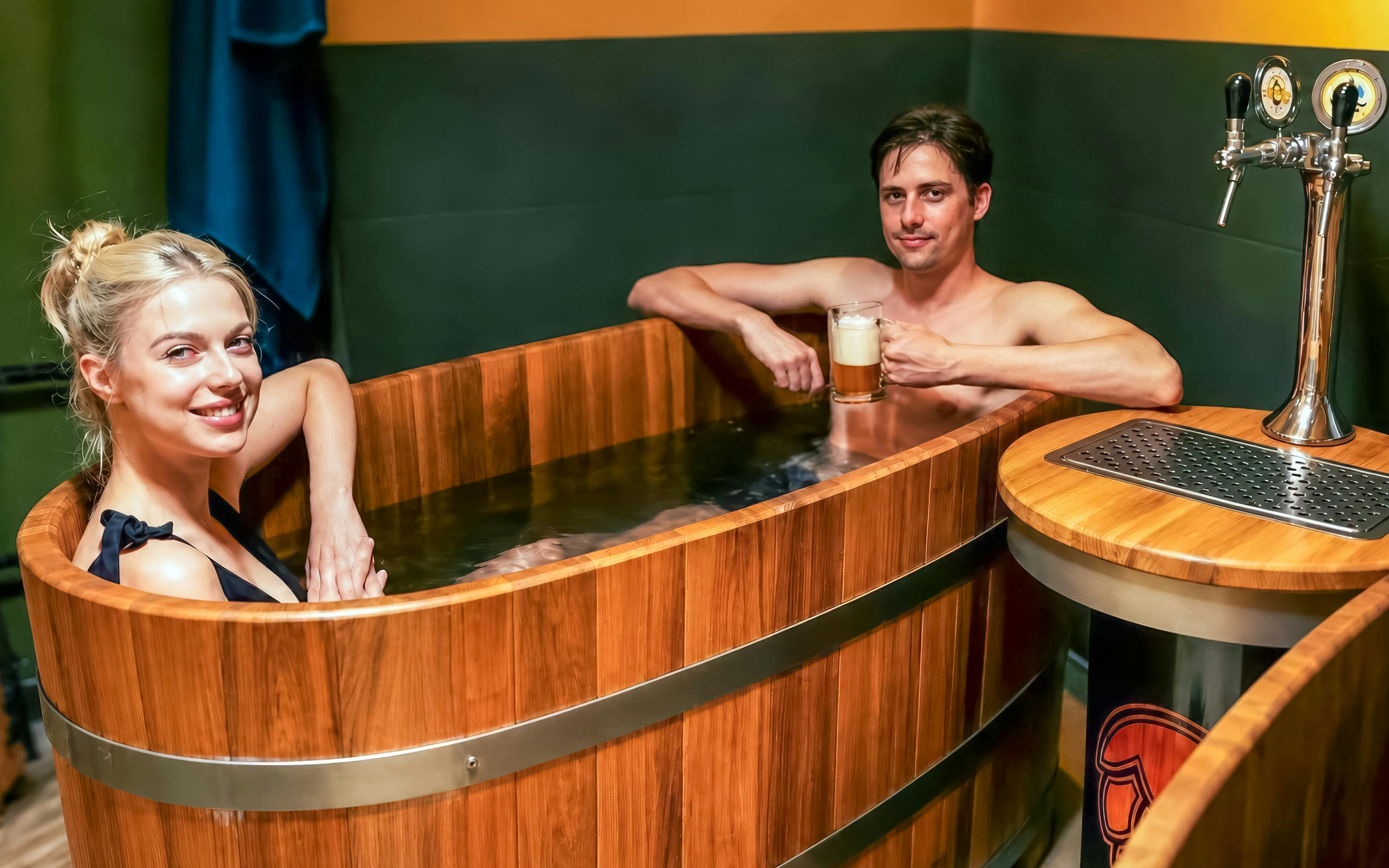 Couple enjoying beer spa in wooden tubs at Budapest's Lukács Thermal Bath.