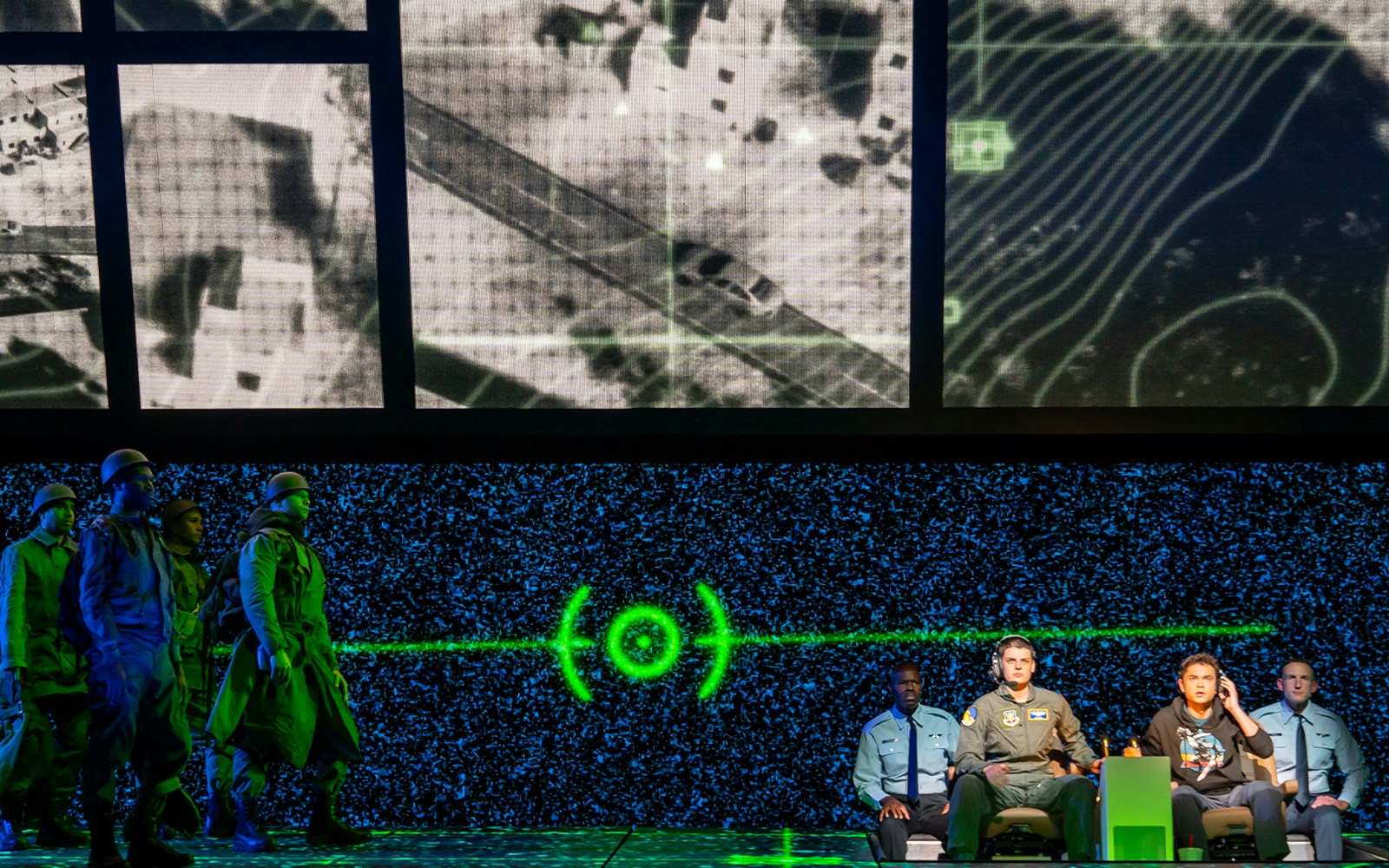 Military personnel in front of a digital map display during a strategic operation.