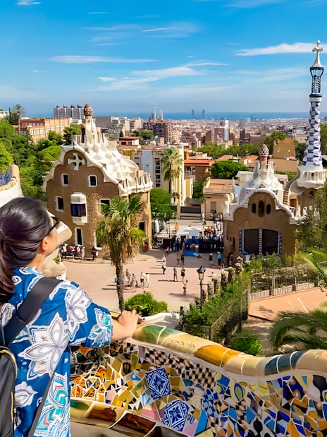 View from Park Güell terrace overlooking Barcelona cityscape.