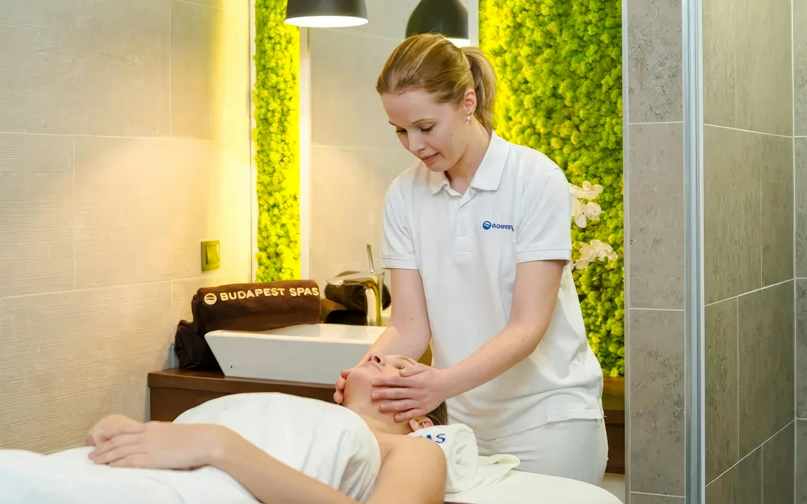 Therapist giving a facial massage at Paskal Thermal Bath, Budapest.