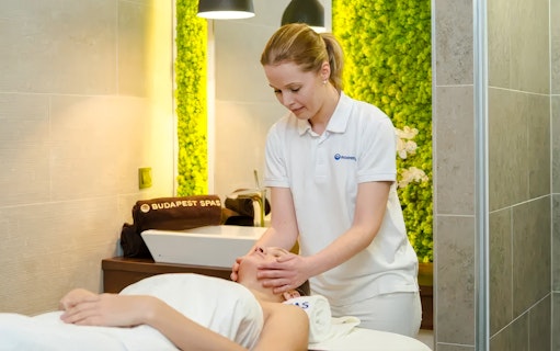 Therapist giving a facial massage at Paskal Thermal Bath, Budapest.