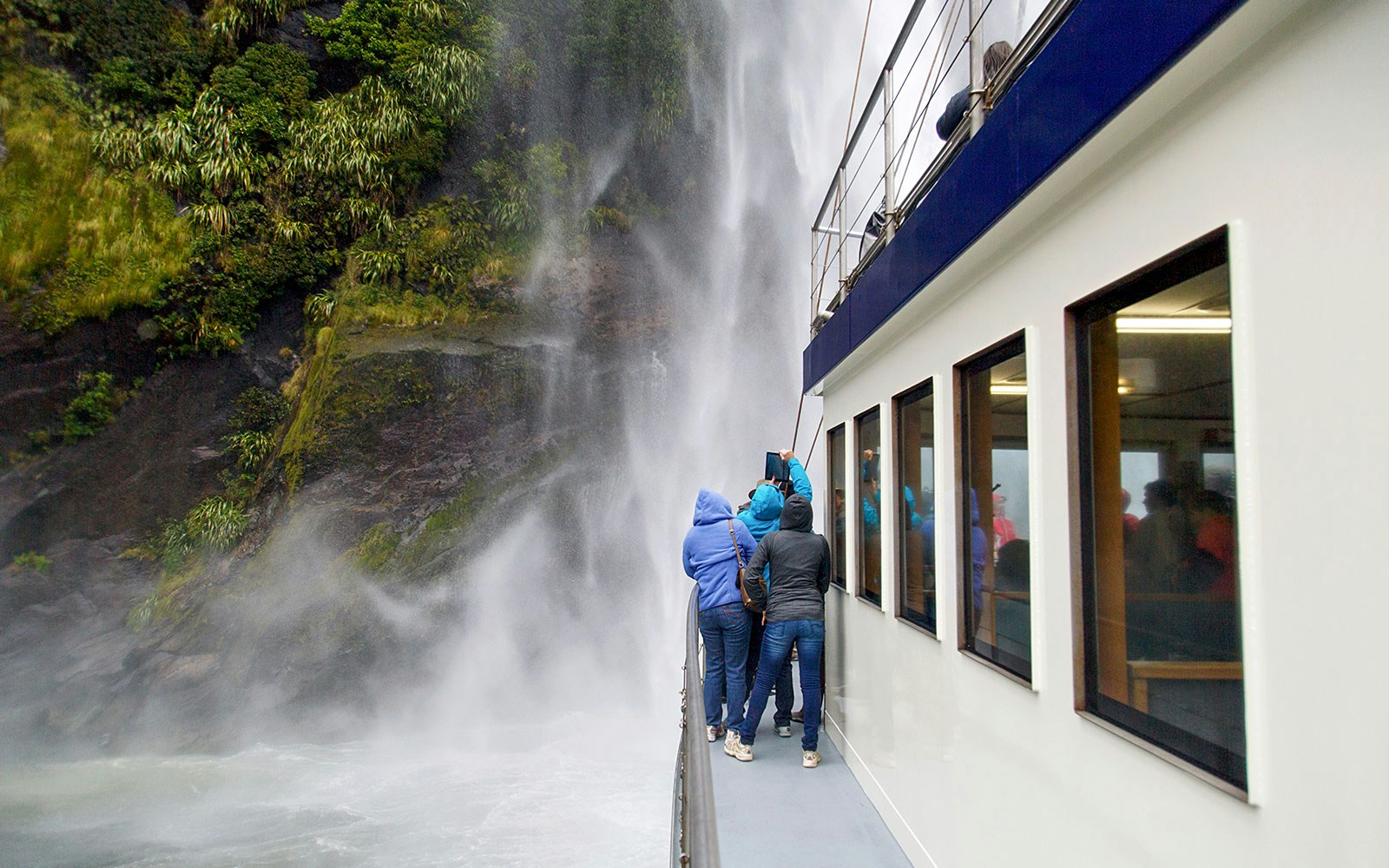 Group on a boat viewing Stirling Falls at Milford Sound.