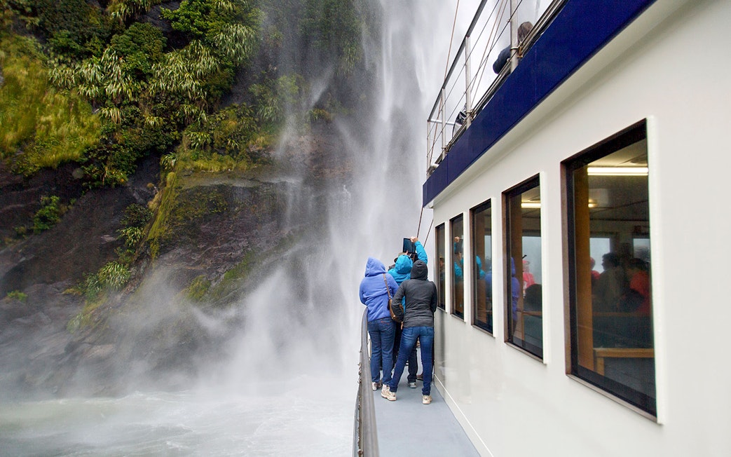 Group on a boat viewing Stirling Falls at Milford Sound.