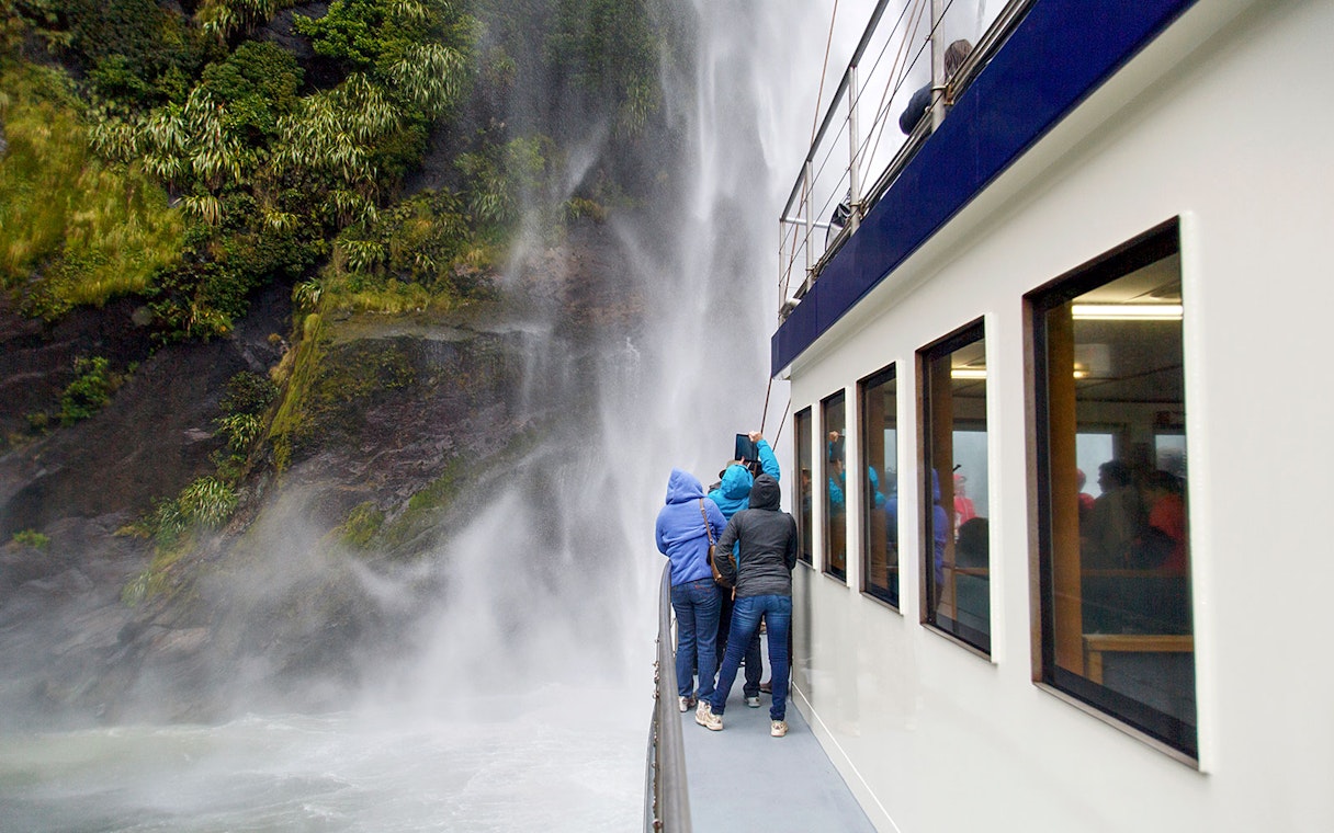 Group on a boat viewing Stirling Falls at Milford Sound.