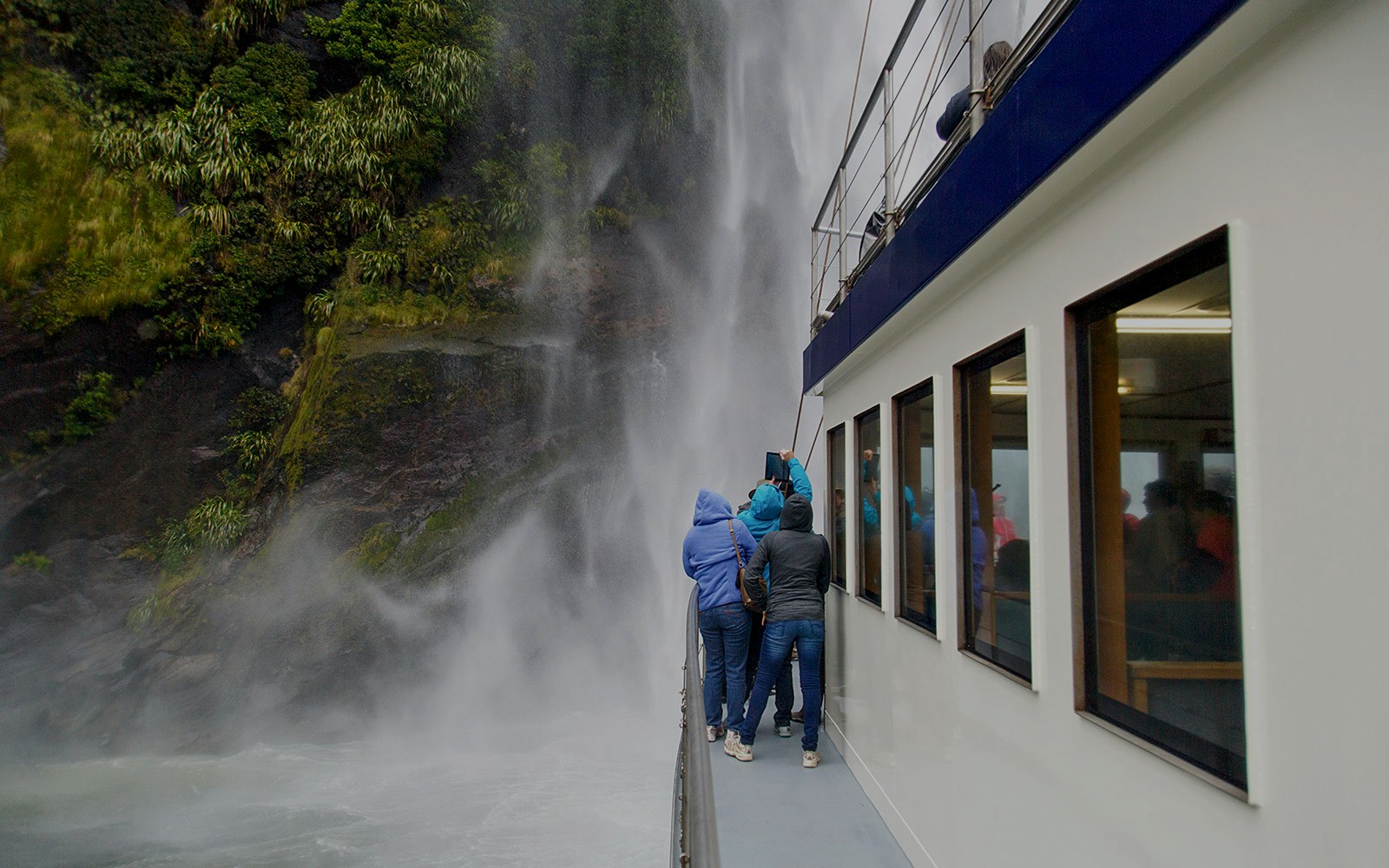 Group of people enjoying Stirling falls at Milford Sound Cruise