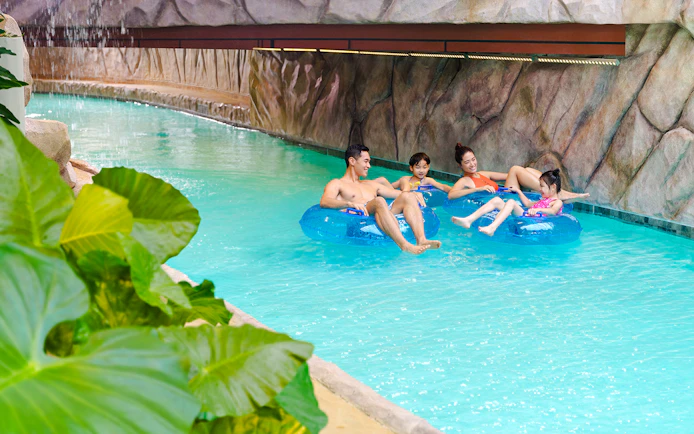 Family enjoying lazy river at Water World Ocean Park, Hong Kong.