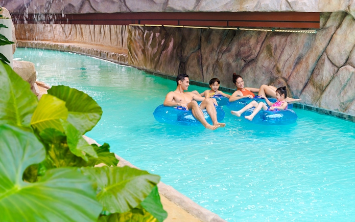 Family enjoying lazy river at Water World Ocean Park, Hong Kong.