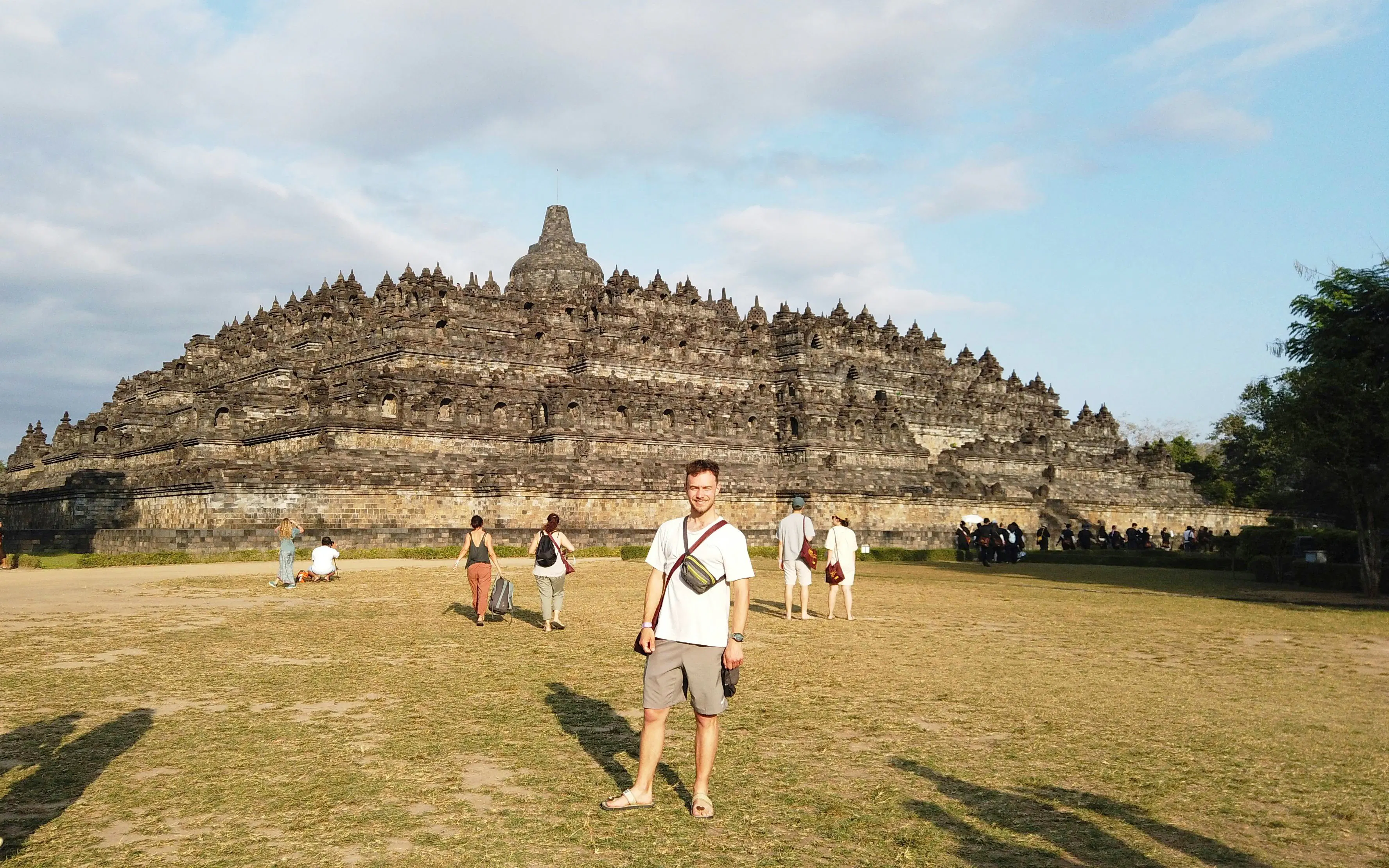 Visitors exploring Borobudur Temple in Indonesia during a guided tour.