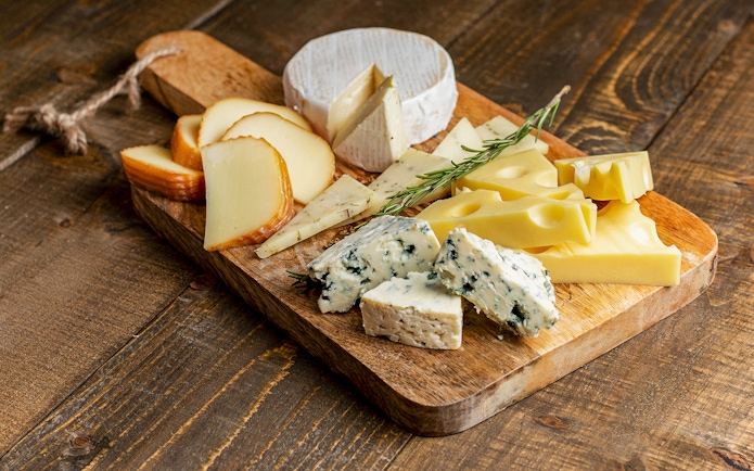 Cheese selection on wooden board at Medieval Dinner Show.