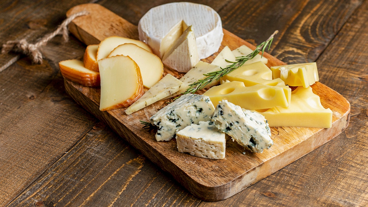 Cheese plate with assorted cheeses and grapes at Prague Medieval Dinner Show.