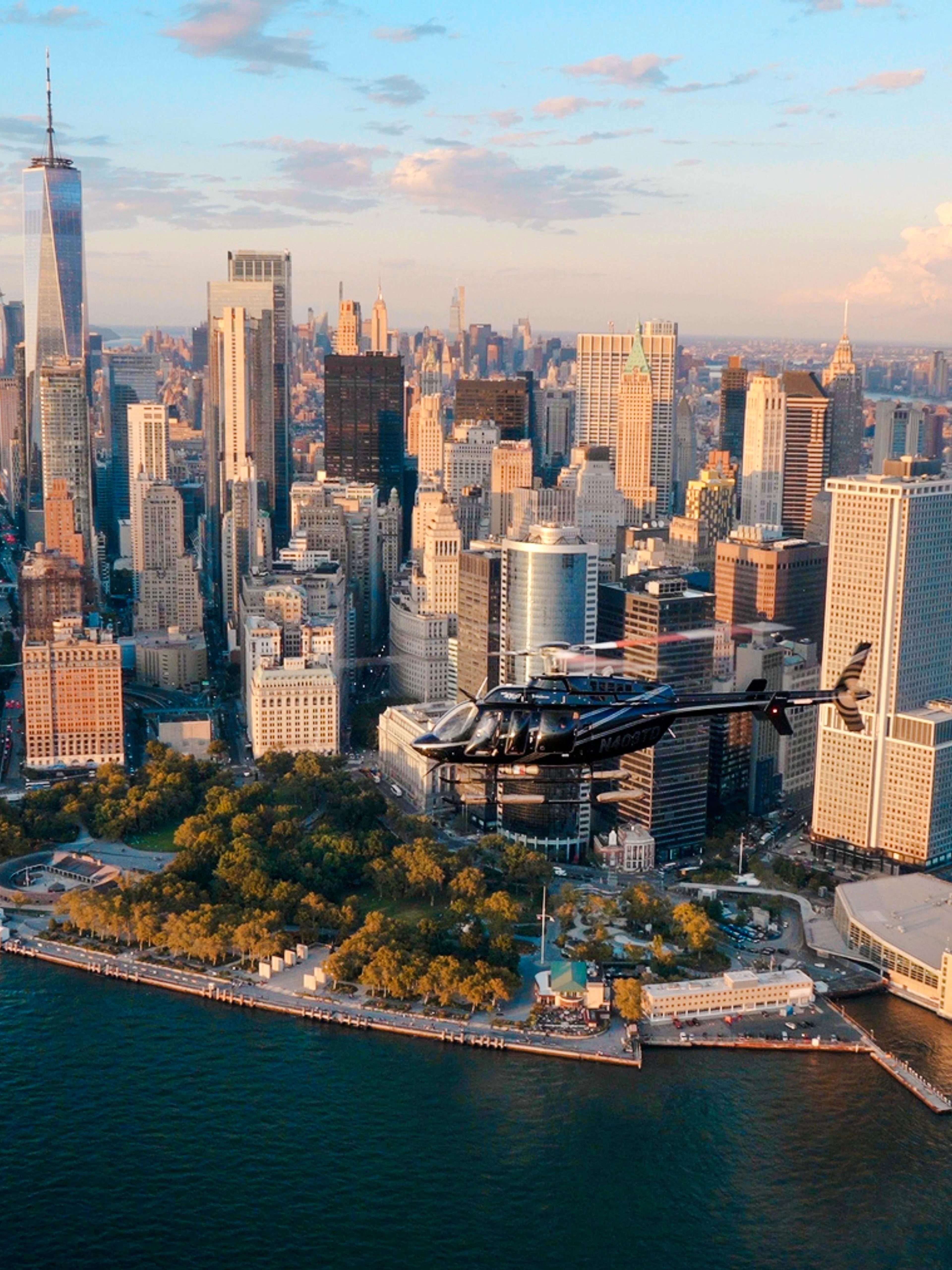 Helicopter flying over Lower Manhattan skyline, New York City.