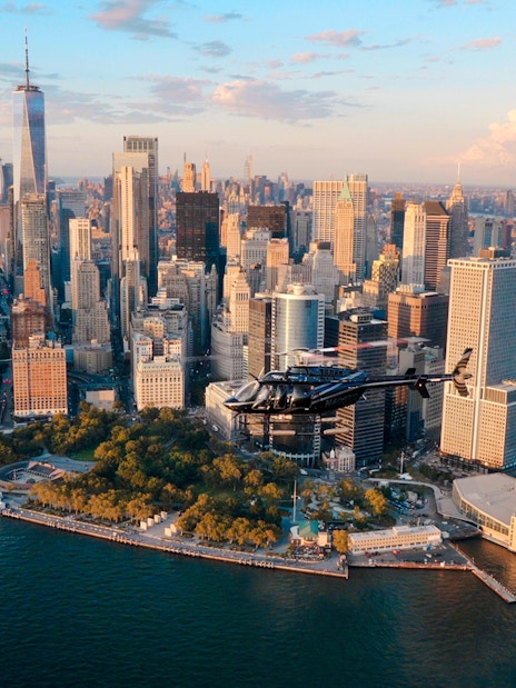 Helicopter flying over Lower Manhattan skyline, New York City.