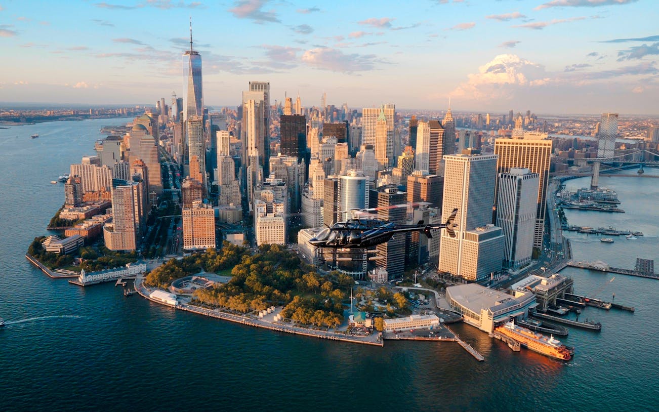 Helicopter flying over Lower Manhattan skyline, New York City.